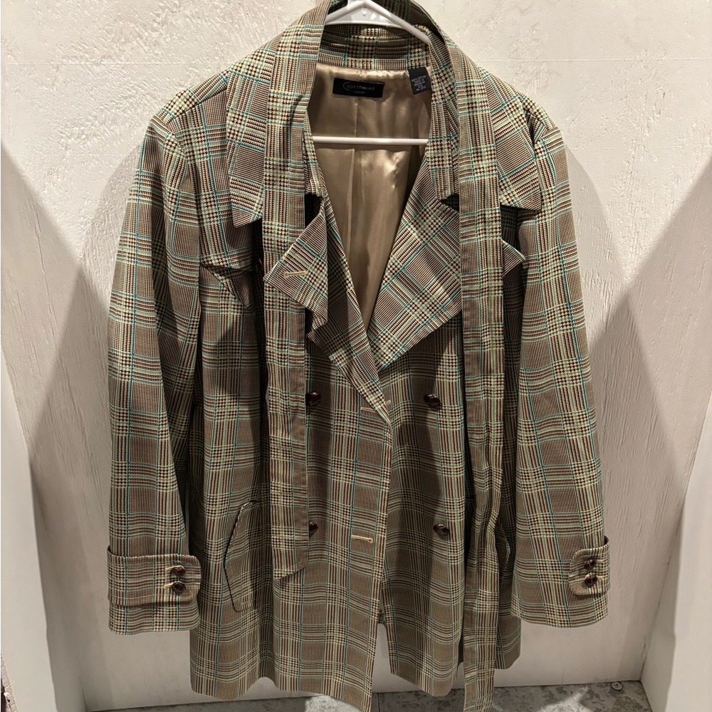 A stripped black and blue and white short luxury trench coat .